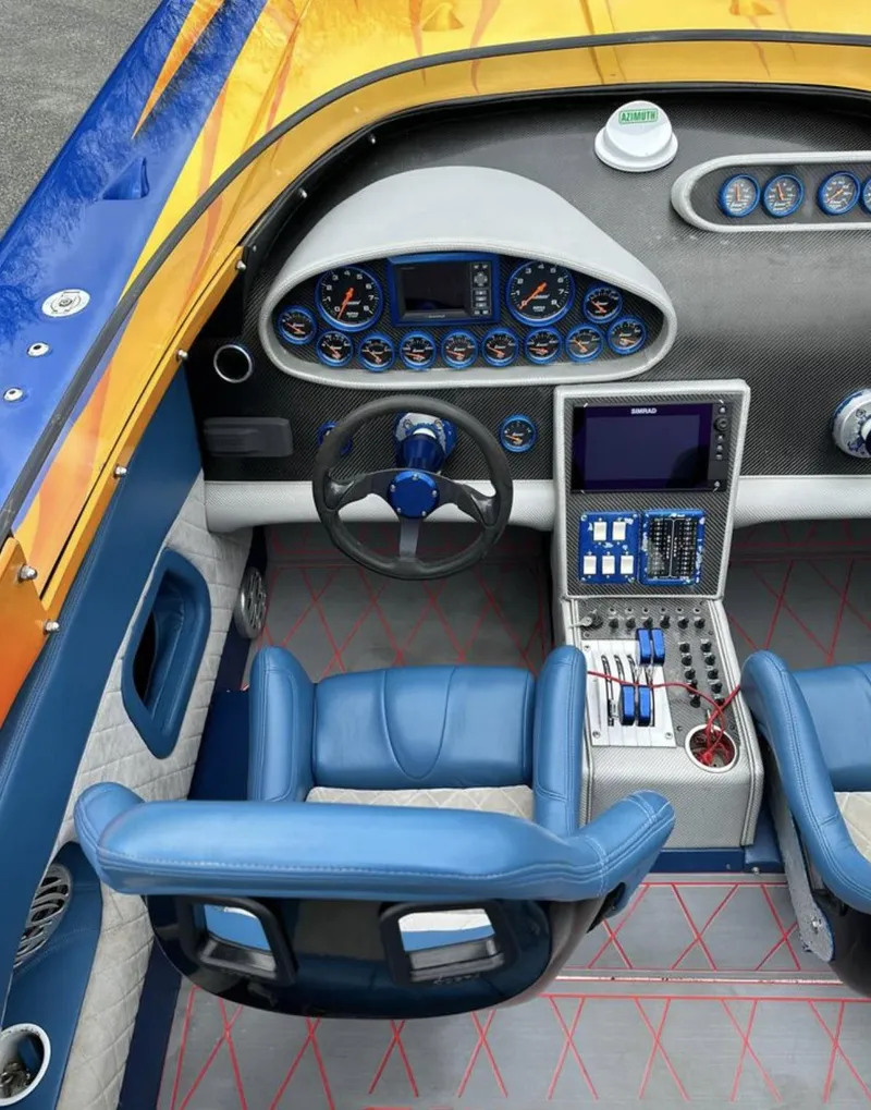 Slide: The Image of 2003 Outerlimits 42 GTX boat cockpit with blue seats and advanced control panel. - 15