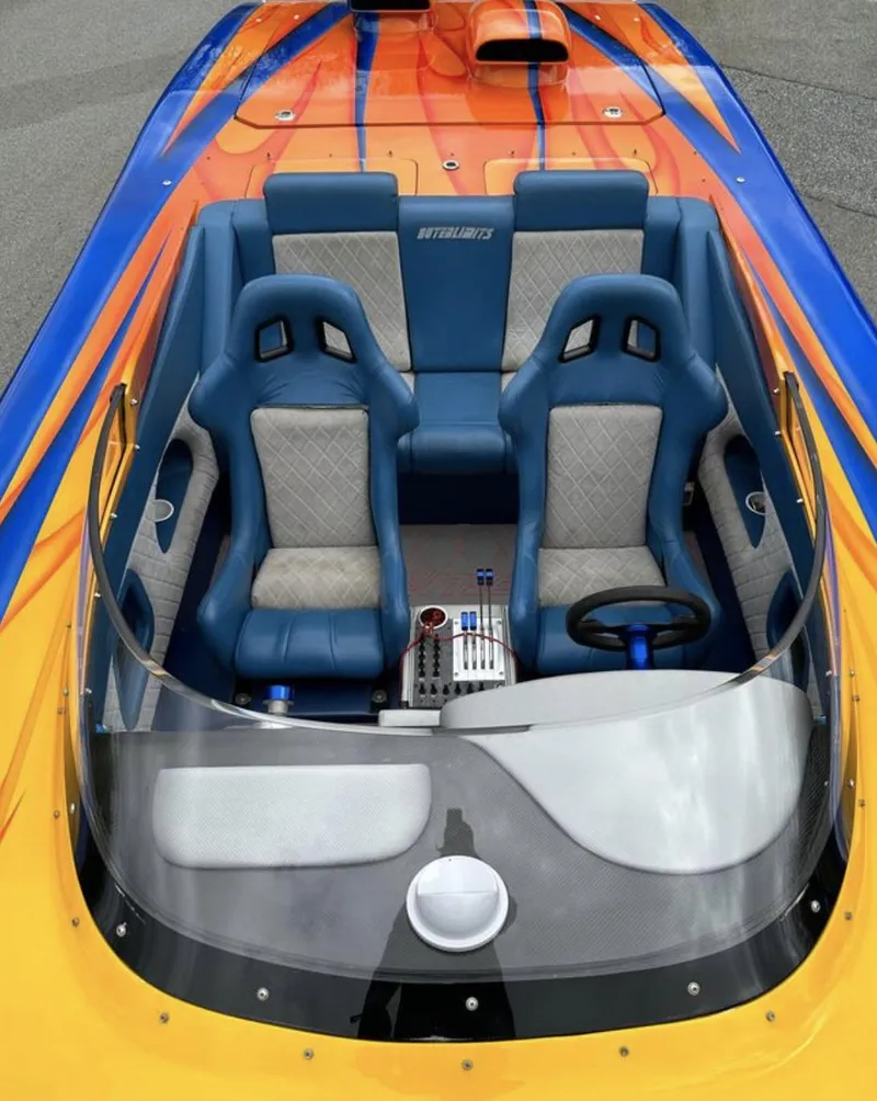 Slide: The Image of 2003 Outerlimits 42 GTX cockpit with blue and gray seats. - 16
