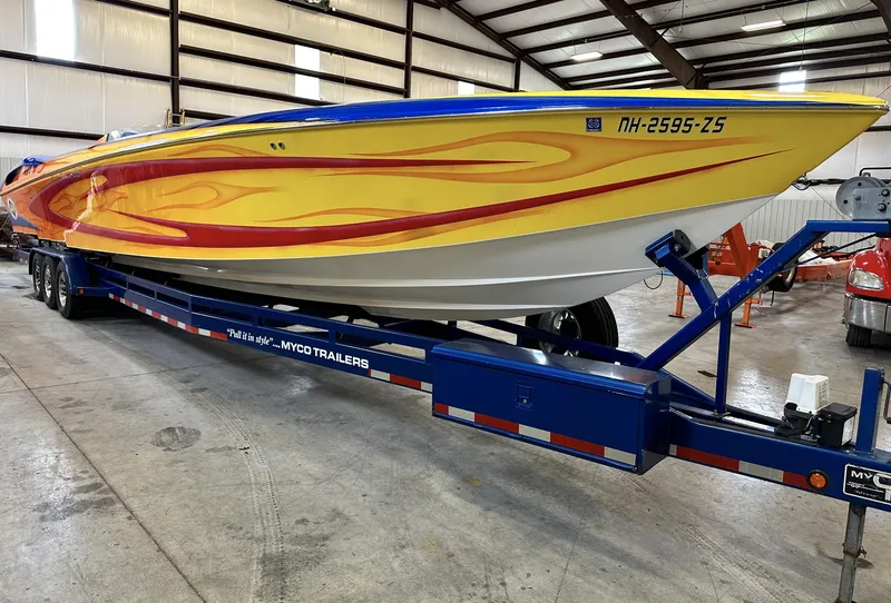 Slide: The Image of 2003 Outerlimits 42 GTX speedboat on a Myco trailer in a warehouse. - 3