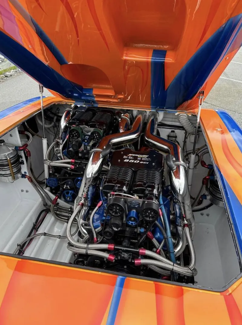 Slide: The Image of 2003 Outerlimits 42 GTX boat engine compartment with vibrant orange and blue accents. - 6
