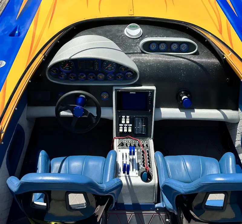 Slide: The Image of 2003 Outerlimits 42 GTX boat cockpit with blue seats and advanced controls. - 8