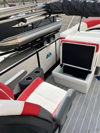Slide: The Image of 2023 South Bay 525 RS Arch 3.0+ pontoon boat interior with red and white seating. - 12
