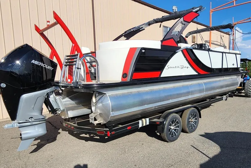 Slide: The Image of 2023 South Bay 525 RS Arch 3.0+ pontoon boat on a trailer, rear view. - 5