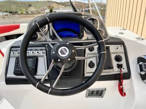 Slide: The Image of Steering console of 2023 South Bay 525 RS Arch 3.0+ boat with modern controls. - 6