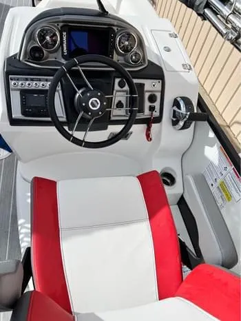 Slide: The Image of 2023 South Bay 525 RS Arch 3.0+ boat dashboard with red and white seating. - 7