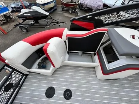 Slide: The Image of 2023 South Bay 525 RS Arch 3.0+ boat interior with red and white seating. - 9