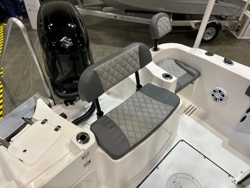 Slide: The Image of 2024 Polar 220 boat interior with gray quilted seats and black motor. - 13