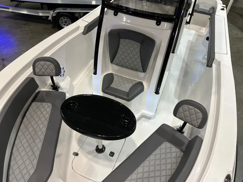Slide: The Image of 2024 Polar 220 boat interior with gray diamond-stitched seating and black table. - 2