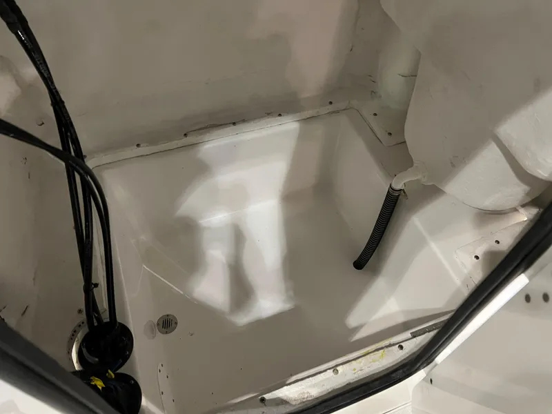 Slide: The Image of 2024 Polar 220 boat interior compartment with wiring and drainage. - 5
