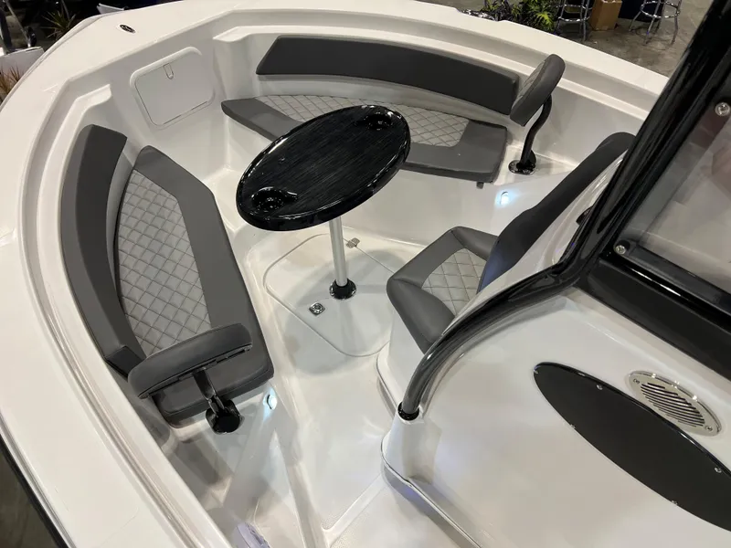Slide: The Image of 2024 Polar 220 boat interior with gray seating and black table. - 8