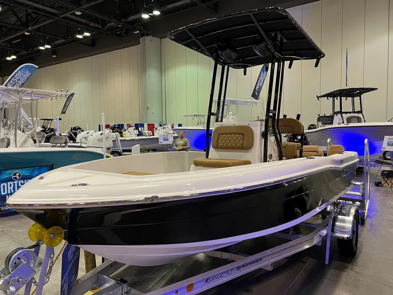 Slide: The Image of 2024 Clearwater 1900 boat on display at an indoor boat show. - 0