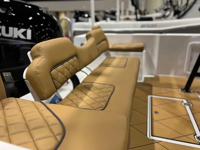 Slide: The Image of 2024 Clearwater 1900 boat with tan quilted seating and Suzuki outboard motor. - 10