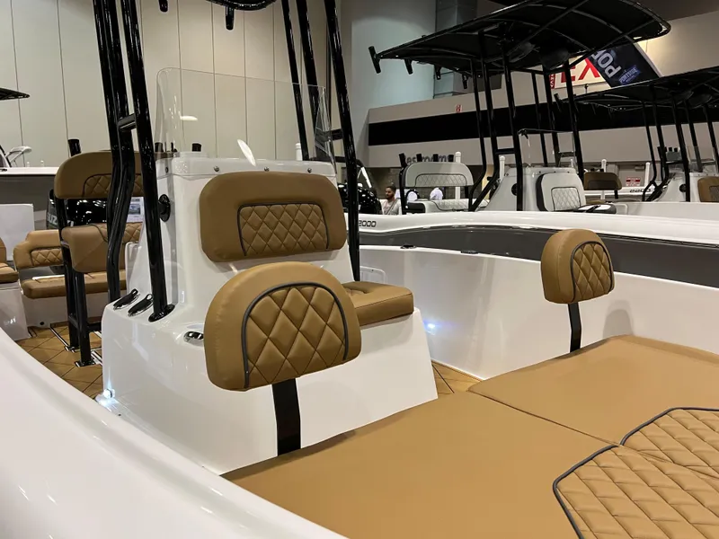 Slide: The Image of 2024 Clearwater 1900 boat interior with tan cushioned seating and black accents. - 12