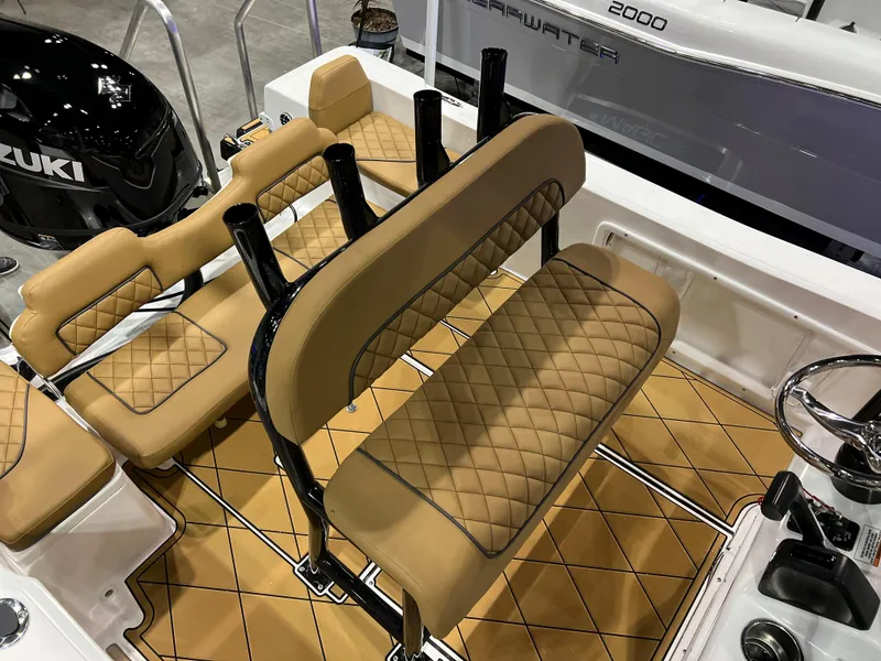Slide: The Image of 2024 Clearwater 1900 boat interior with tan diamond-stitched seats and Suzuki outboard motor. - 15