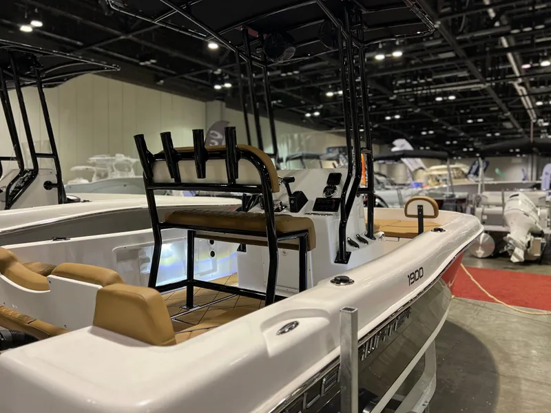 Slide: The Image of 2024 Clearwater 1900 boat on display at an indoor boat show. - 2