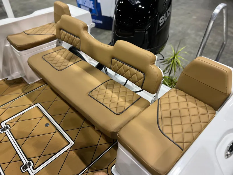 Slide: The Image of Clearwater 1900 2024 model boat with tan diamond-stitched seating and Suzuki outboard motor. - 20