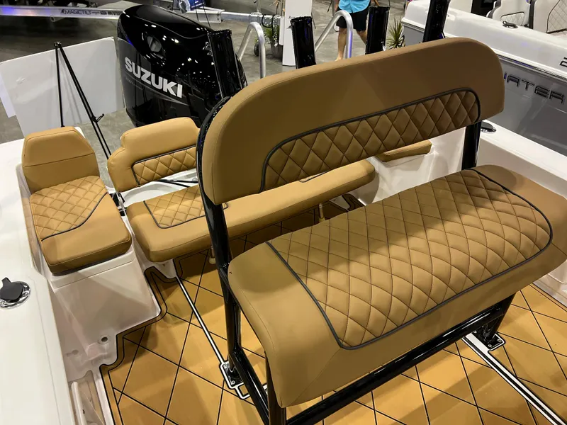 Slide: The Image of Clearwater 1900 2024 boat interior with tan diamond-stitched seats and Suzuki outboard motor. - 21