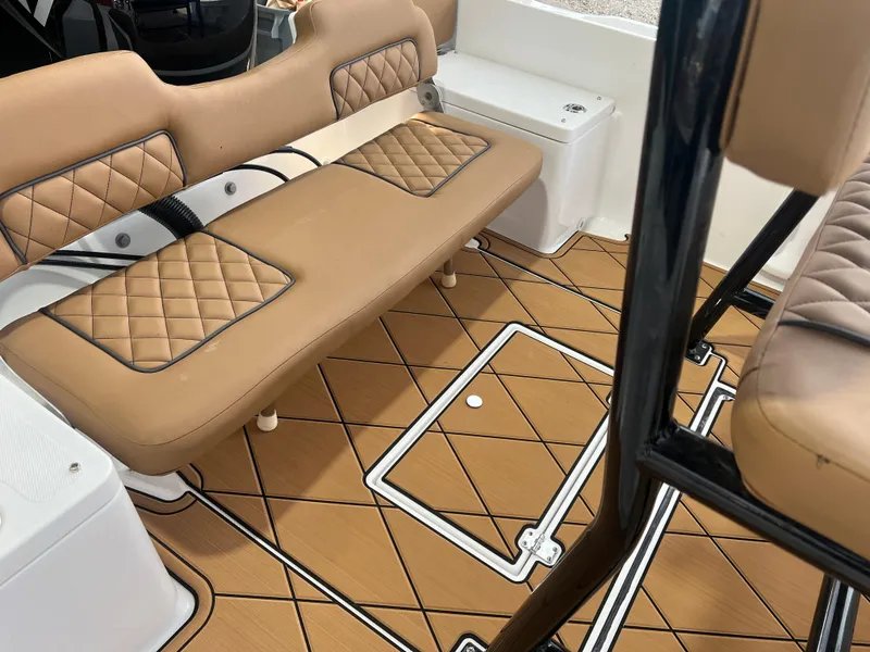 Slide: The Image of Clearwater 1900 2024 model boat interior with tan cushioned seating and diamond-patterned flooring. - 22