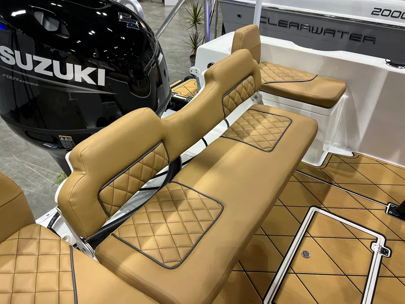 Slide: The Image of 2024 Clearwater 1900 boat with tan diamond-stitched seating and Suzuki outboard motor. - 3