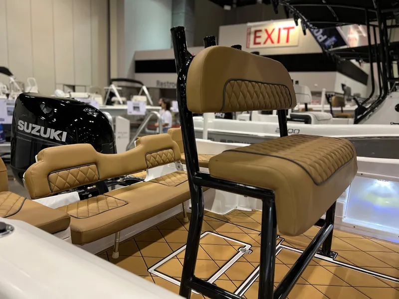 Slide: The Image of 2024 Clearwater 1900 boat interior with tan seating and Suzuki engine. - 4
