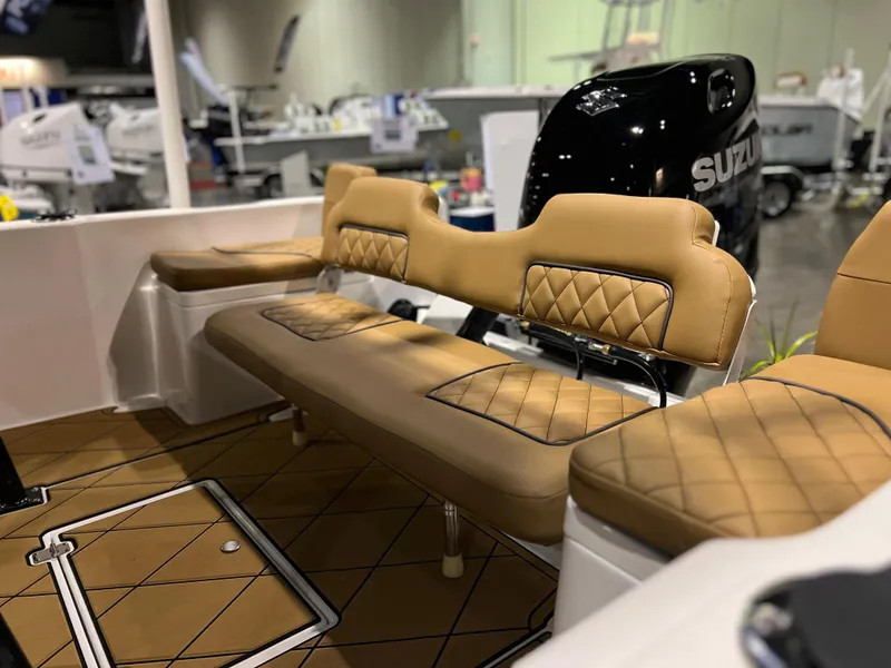 Slide: The Image of 2024 Clearwater 1900 boat interior with tan diamond-stitched seating and Suzuki outboard motor. - 5
