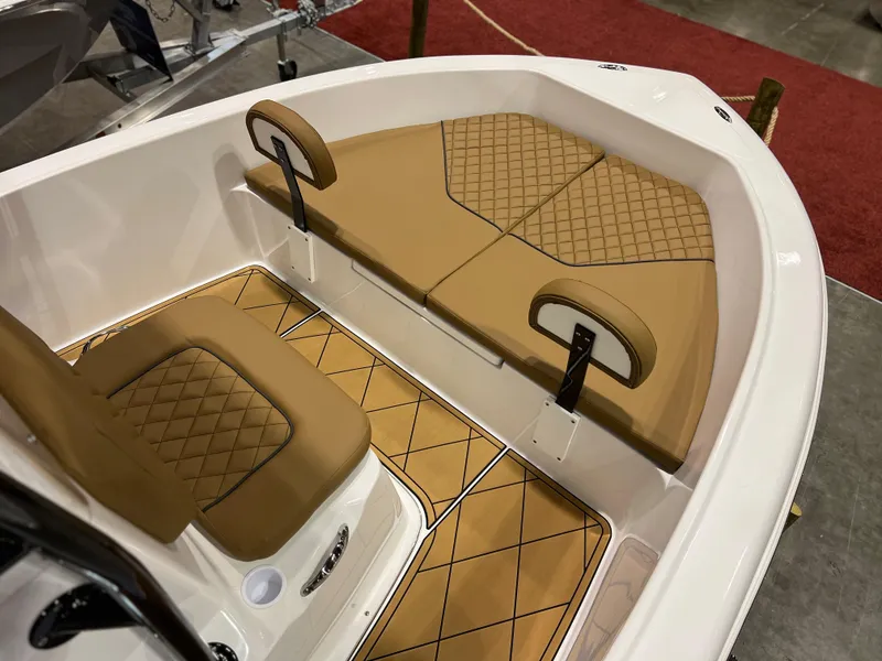 Slide: The Image of Clearwater 1900 2024 model boat interior with tan diamond-stitched seating and flooring. - 8