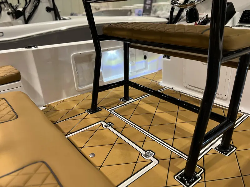 Slide: The Image of 2024 Clearwater 1900 boat interior with tan diamond-stitched seats and non-slip flooring. - 9