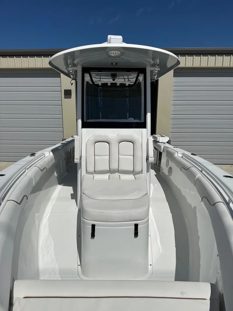 Slide: The Image of 2018 Sea Hunt GAMEFISH 27 CB boat with center console and cushioned seating. - 10