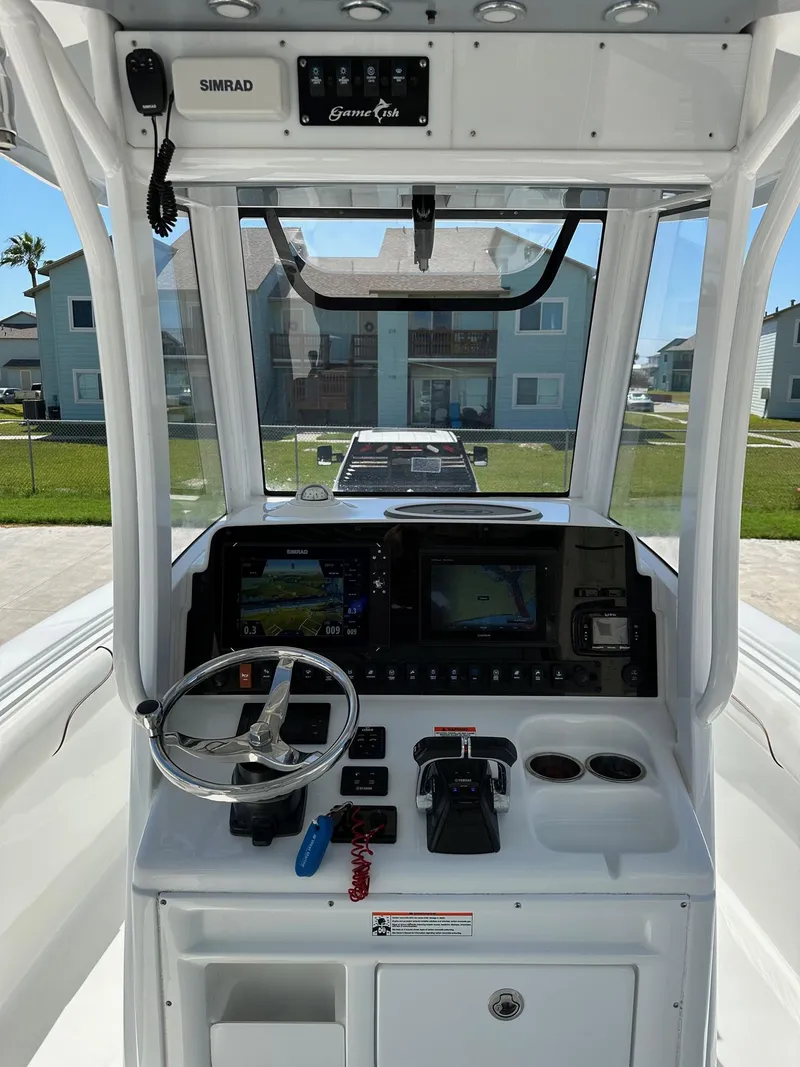 Slide: The Image of 2018 Sea Hunt GAMEFISH 27 CB boat console with navigation and control systems. - 3