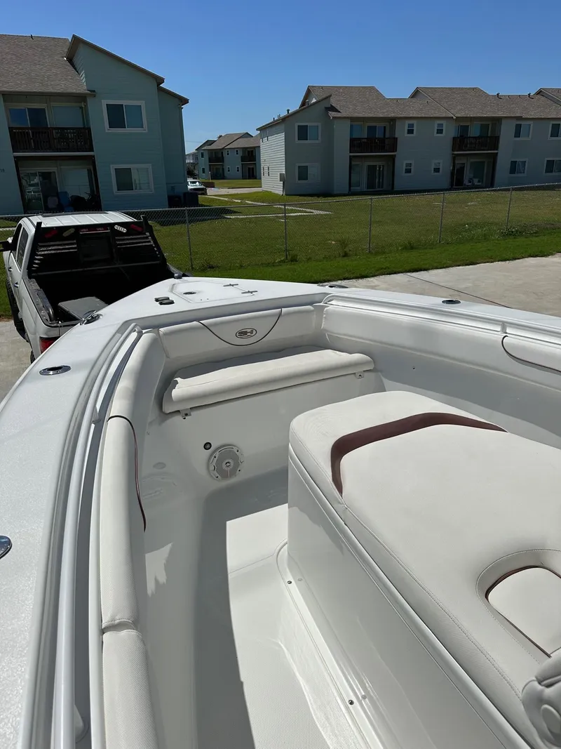 Slide: The Image of 2018 Sea Hunt GAMEFISH 27 CB boat interior with residential background. - 8