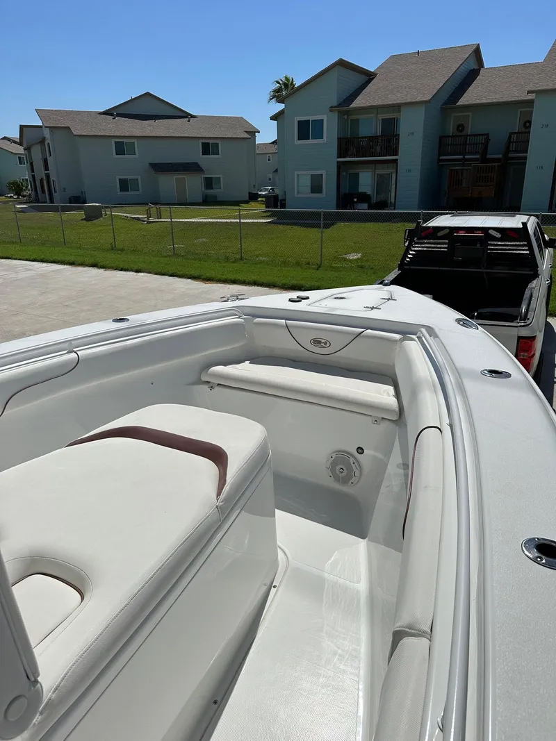 Slide: The Image of 2018 Sea Hunt GAMEFISH 27 CB boat interior with residential background. - 9