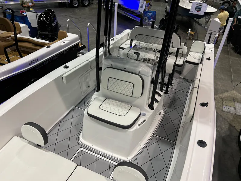 Slide: The Image of 2024 Clearwater 2000 boat interior with white cushioned seating and modern design. - 12