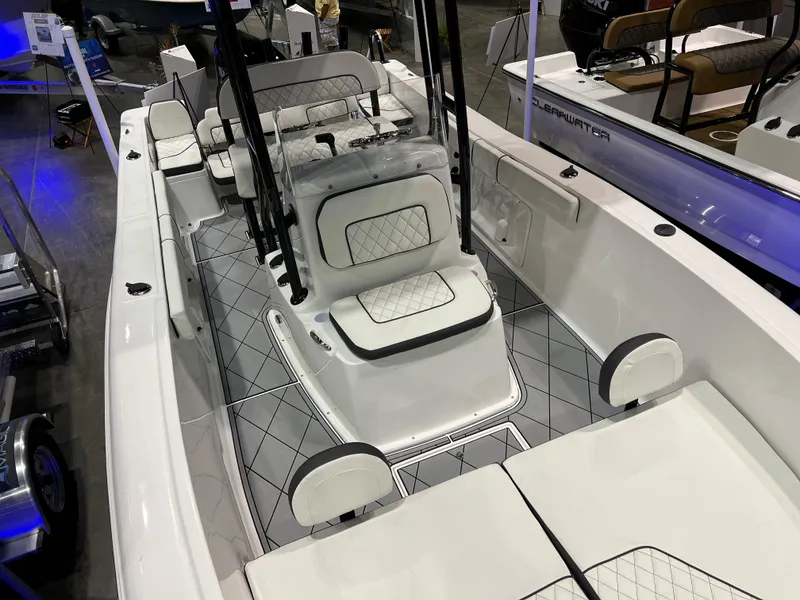 Slide: The Image of 2024 Clearwater 2000 boat interior with white seating and diamond-patterned flooring. - 14