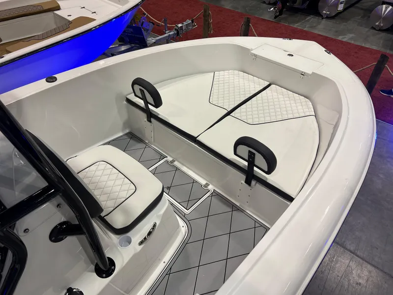 Slide: The Image of 2024 Clearwater 2000 boat interior with white cushioned seating and diamond-patterned flooring. - 15