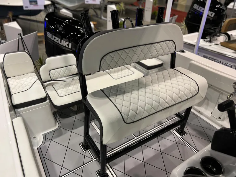 Slide: The Image of Clearwater 2000 boat interior, 2024 model, featuring white quilted seats and Suzuki outboard motor. - 16