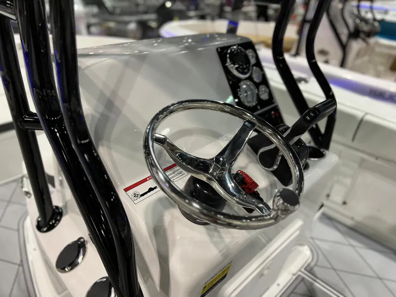 Slide: The Image of Clearwater 2000 2024 boat console with steering wheel and control panel. - 19