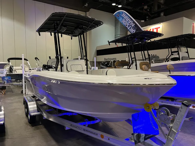 Slide: The Image of Clearwater 2000 boat model 2024 displayed at a boat show on a trailer. - 2