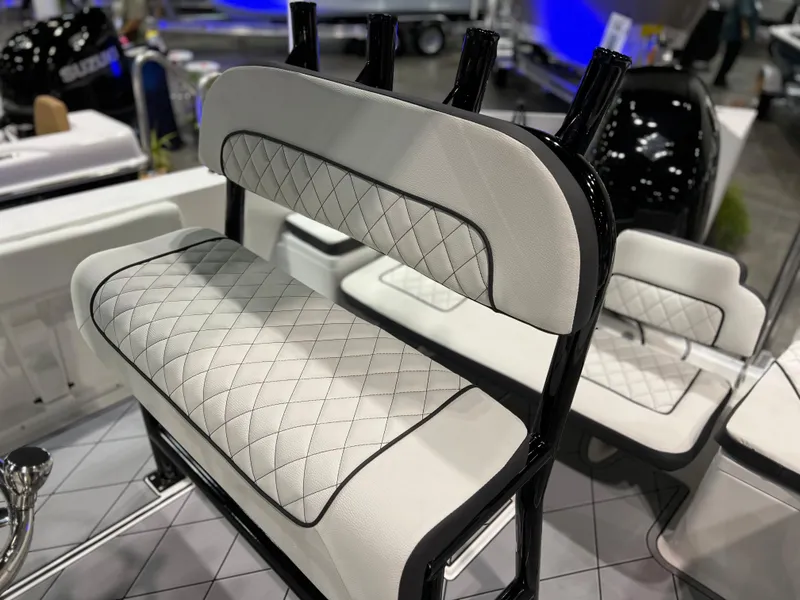 Slide: The Image of Clearwater 2000 2024 model boat seat with diamond-stitched upholstery at a boat show. - 20