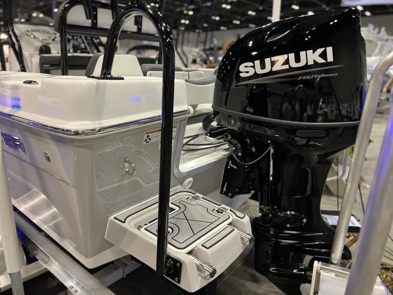 Slide: The Image of 2024 Clearwater 2000 boat with Suzuki outboard motor at a boat show. - 23