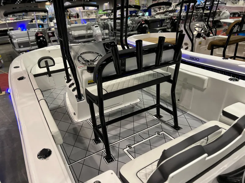 Slide: The Image of 2024 Clearwater 2000 boat interior with seating and steering console at a boat show. - 27