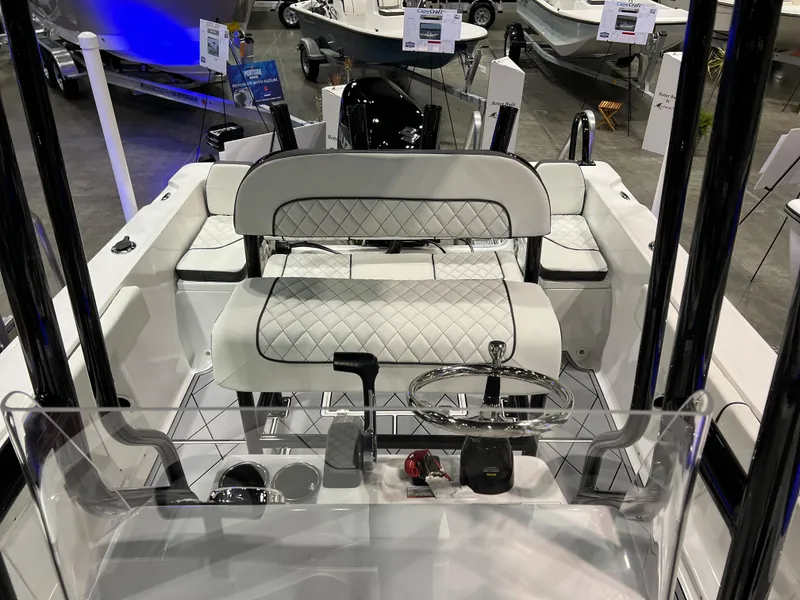 Slide: The Image of 2024 Clearwater 2000 boat interior with white quilted seating and steering console. - 6