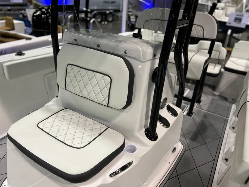 Slide: The Image of 2024 Clearwater 2000 boat interior with white cushioned seating and black accents. - 7