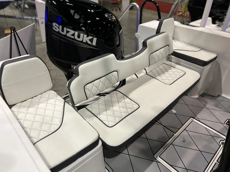 Slide: The Image of Clearwater 2000 2024 boat interior with Suzuki outboard motor and white quilted seats. - 8