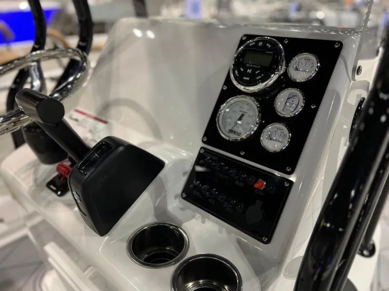 Slide: The Image of Clearwater 2000 2024 boat dashboard with gauges and controls. - 9