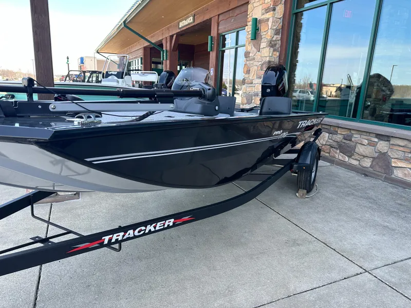 Slide: The Image of 2024 Tracker Pro 170 boat on trailer outside a building. - 2