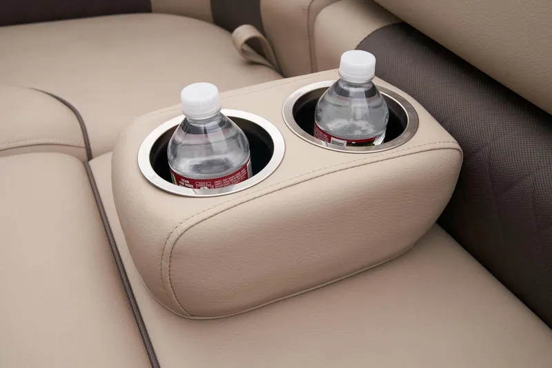 Slide: The Image of Sun Tracker Fishin' Barge 22 XP3 2024 cup holders with water bottles on beige seats. - 26