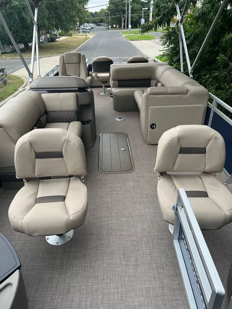 Slide: The Image of 2024 Sun Tracker Fishin' Barge 22 XP3 interior with beige seating. - 10