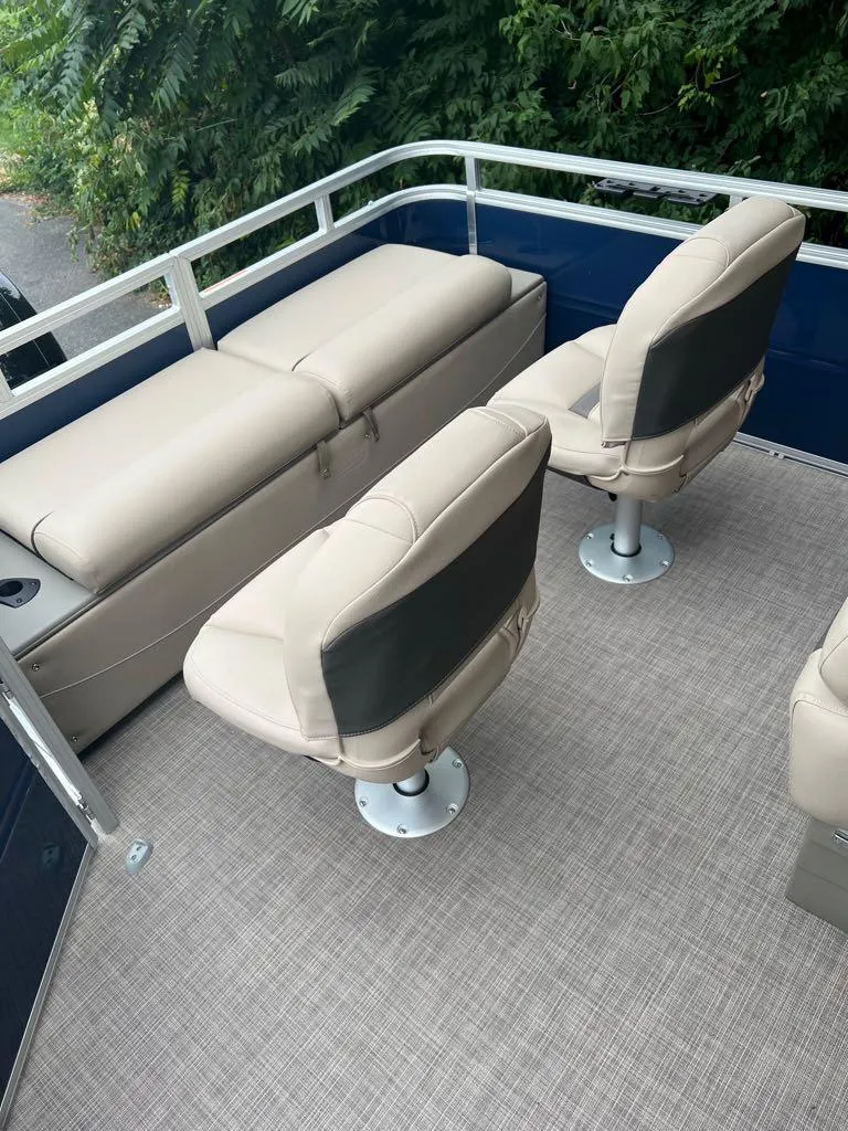 Slide: The Image of 2024 Sun Tracker Fishin' Barge 22 XP3 interior seating area with beige seats. - 7