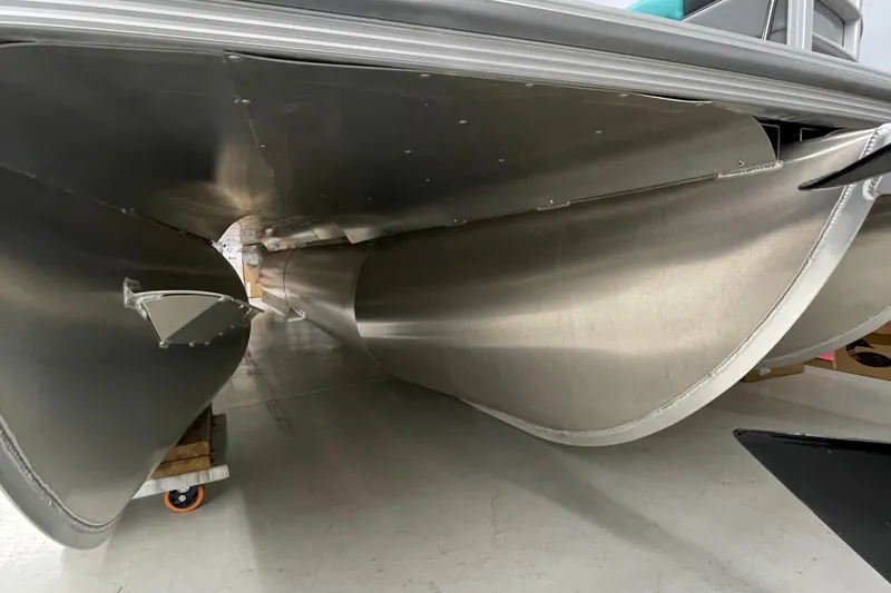 Slide: The Image of 2023 Berkshire 22 RFX CTS pontoon boat undercarriage in a showroom. - 15
