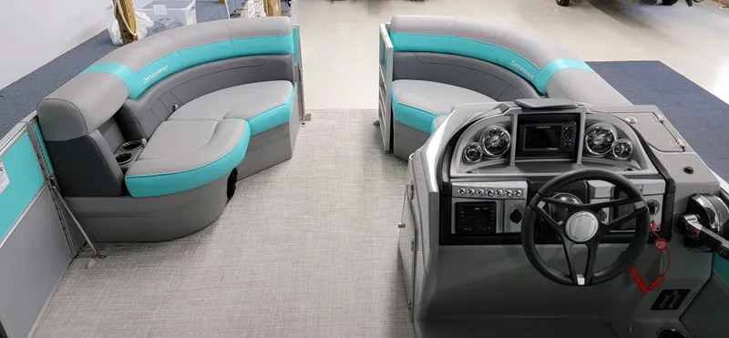 Slide: The Image of 2023 Berkshire 22 RFX CTS pontoon boat interior with teal and gray seating. - 2